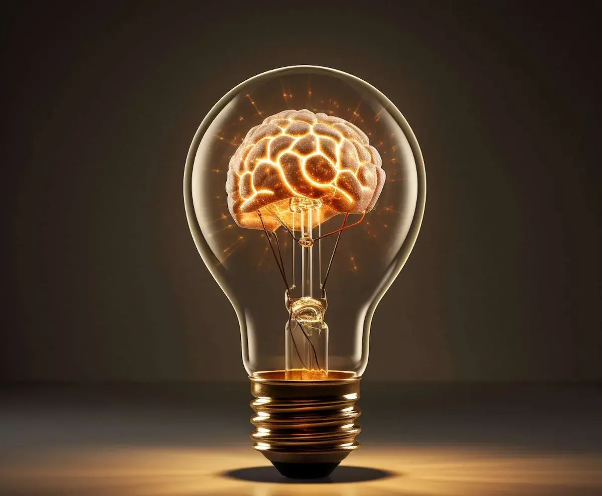 Une ampoule contenant un cerveau lumineux, sur fond sombre